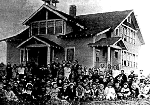 Schoolhouse with students.