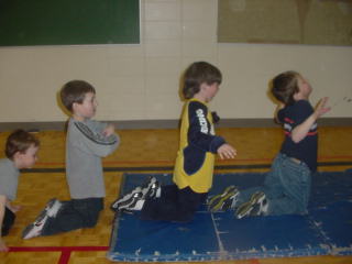 Kindergarten and Grade 1 boys moving fins like birds' wings.